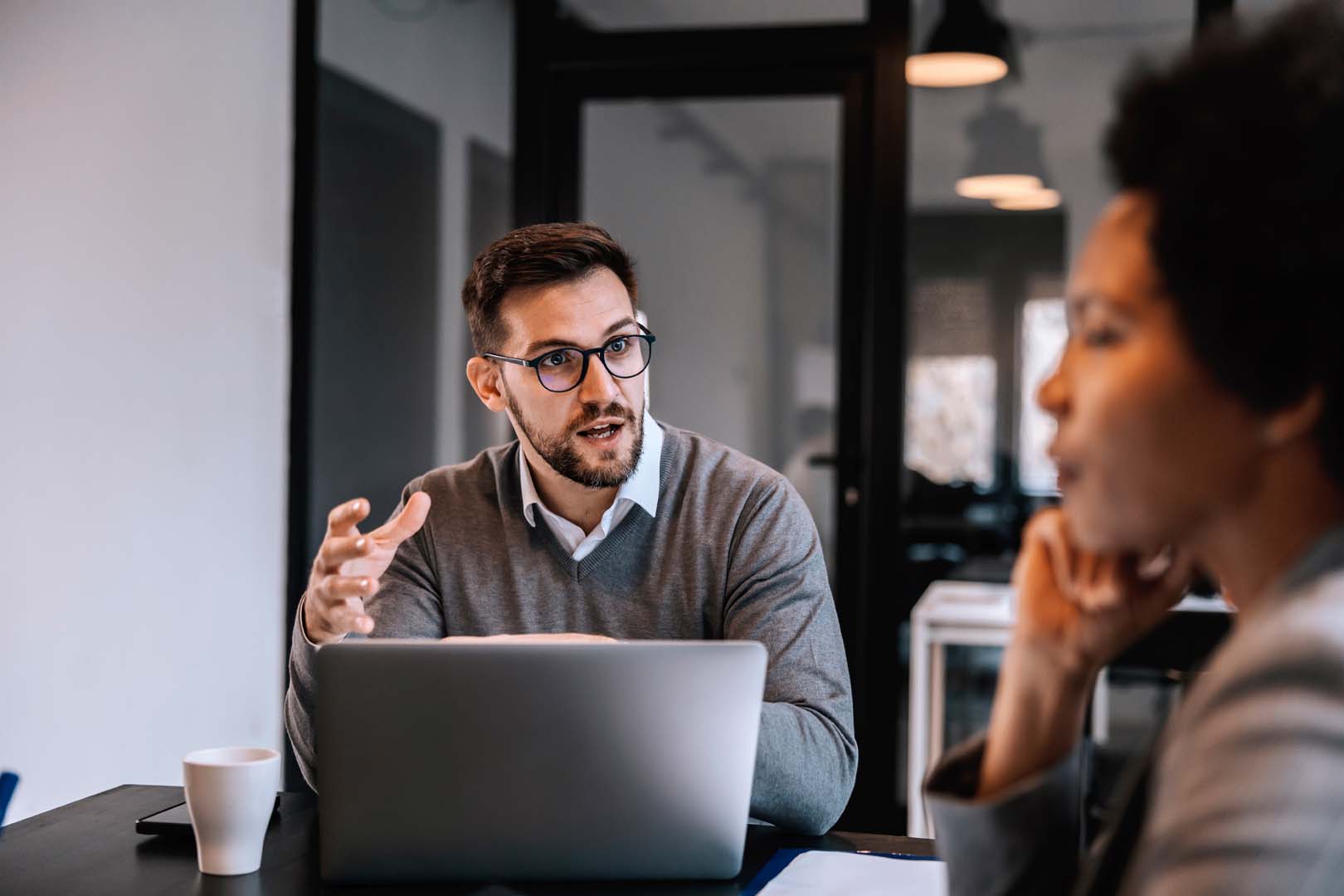 Businessman explaining ideas to another person at the table